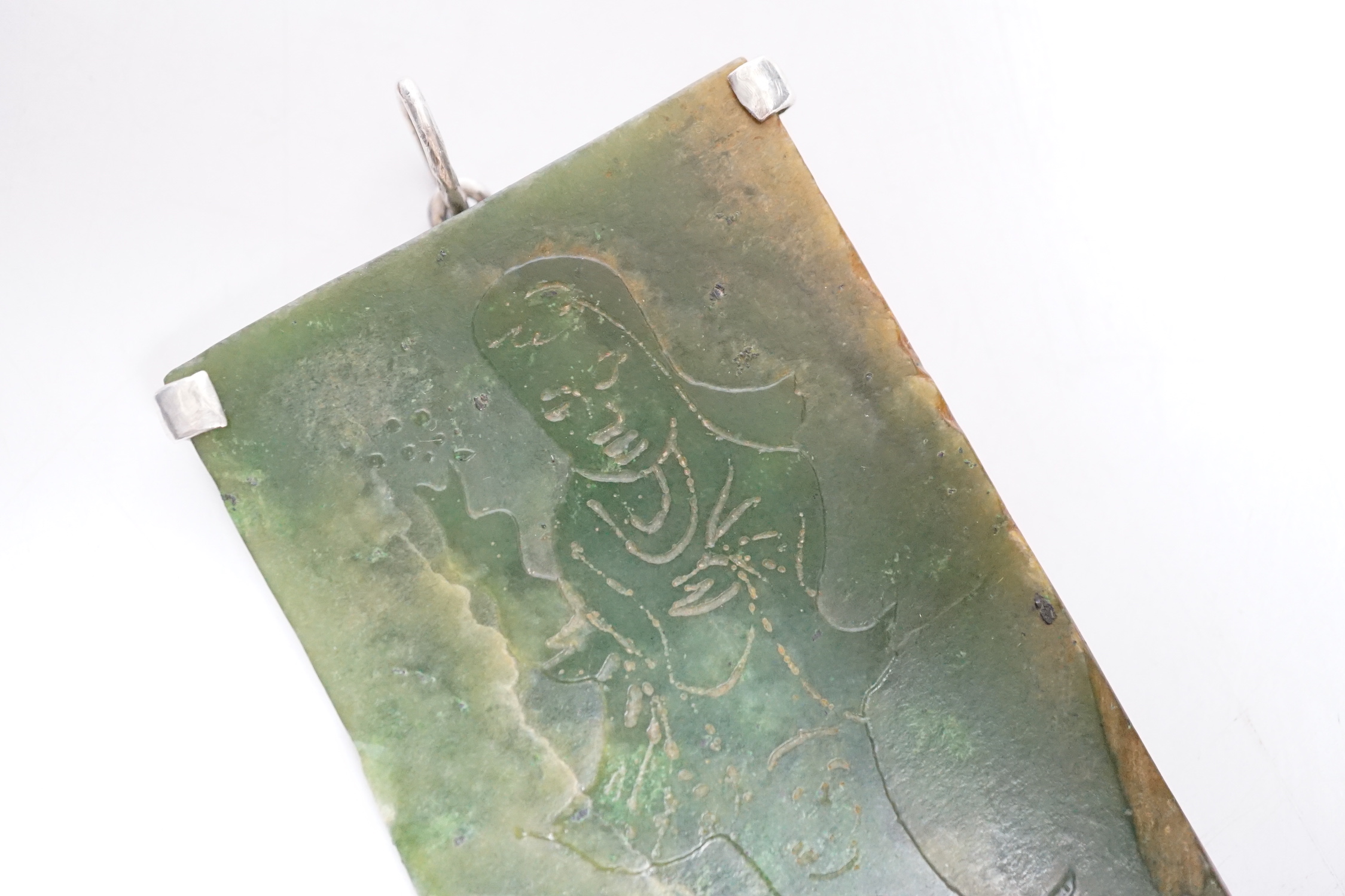 A Chinese carved spinach green jade panel, 9cms high.